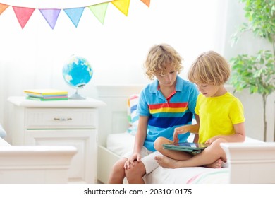 Child With Tablet Computer. Kids Study Online. Bedroom For Two Siblings. Electronic Device For Learning And Studying At Home. Little Boy With Laptop Pc. Gadget Screen Time For Children. Kid At Home. 