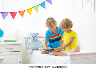 Child With Tablet Computer. Kids Study Online. Bedroom For Two Siblings. Electronic Device For Learning And Studying At Home. Little Boy With Laptop Pc. Gadget Screen Time For Children. Kid At Home. 