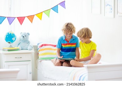 Child With Tablet Computer. Kids Study Online. Bedroom For Two Siblings. Electronic Device For Learning And Studying At Home. Little Boy With Laptop Pc. Gadget Screen Time For Children. Kid At Home. 