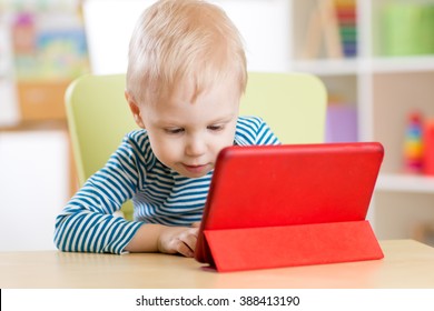 Child With Tablet Pc Computer At Home