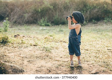 Child Taking A Picture In The Forest