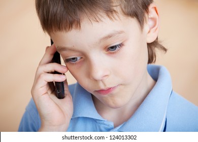 Child, Talking On The Phone. Sad Boy Talking On Mobile Phone