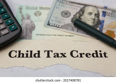 Child Tax Credit - Calculator, Dollar Bill, IRS Check, And Pen