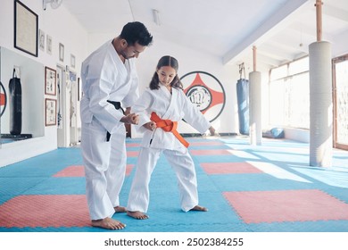 Child, teacher or practice in dojo for martial arts, training or fighting exercise for karate education. Learning skill, warrior or judo master with girl kid in studio for taekwondo lesson or workout