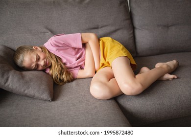 Child Teenager Abdominal Pain. Lying On The Couch