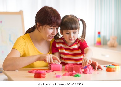 Child With Therapist Playing With Toy The Sand. Psychologist Works, Sand Therapy