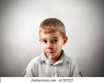 Child With Thermometer In His Mouth