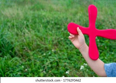 Child Throwing Four Blade Boomerang.