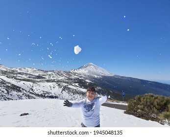 Child Throwing Snow Ball In The Air, Photo Taken At Teide National Park 