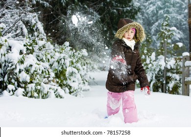 Child Throwing A Snowball