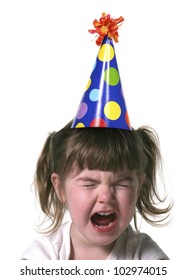 Child Throwing A Tantrum Wearing A Birthday Hat