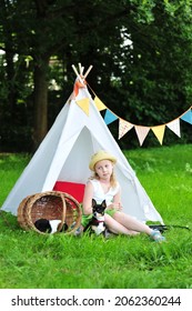 A Child In A Tipi With Her Chihuahua Outside