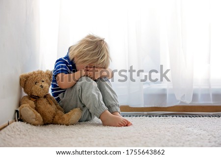 Child, toddler boy, punished in the corner for making mischieves
