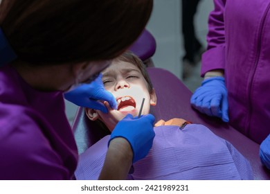 Child with toothache at the dentist's office - Powered by Shutterstock