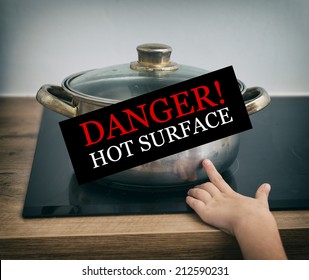 Child touches hot pan on the stove. Dangerous situation at home. 