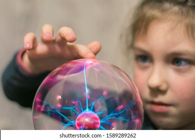 The Child Touches The Plasma Ball With His Finger. Selective Focus.