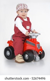 Child and toy - car,little girl governs toy - car on white background.