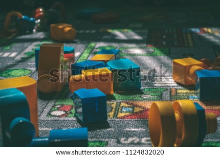 child toys left on the rug in living room. blocks and balls - vintage retro look