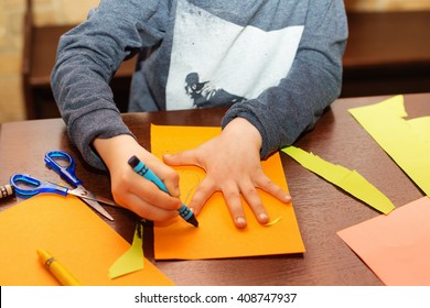 Child Trace Around A Hand On Paper With Crayons. A Simple Drawing Of A Child's Hand. Trace Child Palm. Hand Tracing. Children's Creativity.