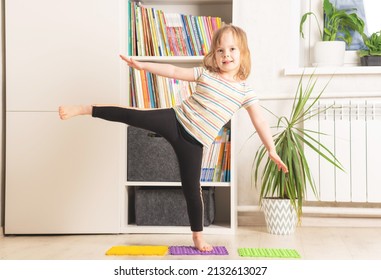 The Child Trains At Home: Fitness, Yoga, Exercises. Distant Training With Personal Trainer, Social Distance, Online Education Concept. Physical And Mental Health Trend