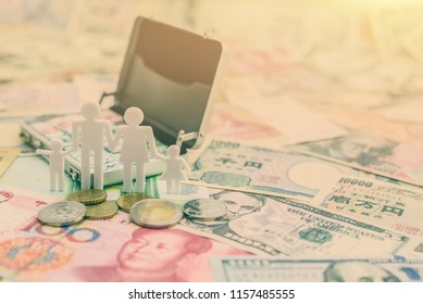 Child Trust Fund / Asset Insurance Concept : Family Members, Father, Mother, Son And Daughter On Bill Notes And Coins With Money Or Cash Briefcase In The Back, Depicts A Long-term Savings For Children