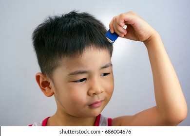 Child Trying To Insert A Memory Card Into His Head