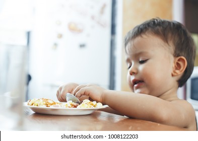 Child T-shirt In The Kitchen Eating Scrambled Eggs, With A Spoon