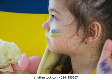 Child With Ukrainian Flag. War In Ukraine. Children Against War. Stop War. Russian-Ukrainian War. UNICEF. Ukrainian Refugees. Peace Concept. Ukrainian Flag On A Child's Face