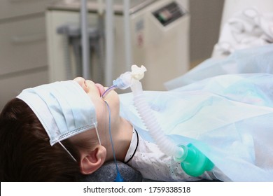 A Child Under Anesthesia. Breathing Tube In The Trachea. Concept Of Health Care And Life Saving. Copy Space.