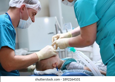 The Child Is Under Anesthesia. A Breathing Tube Is Inserted Into The Trachea. Preparing For Surgery. Treatment Of Multiple Caries. Operation In The Dental Clinic.