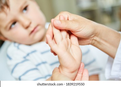 Child Undergoing Osteopathy Or Physiotherapy For Wrist Pain