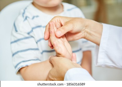 Child Undergoing Osteopathy Or Physiotherapy For Wrist Pain