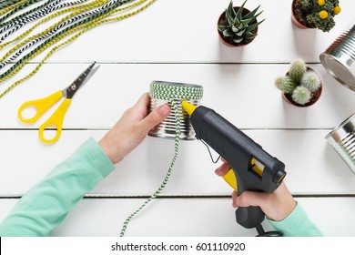 Child Used Electric Hot Glue Gun To Attach Green, White Braid To Metal Tin. Children Education Concept. Kids Crafts. Step 3.