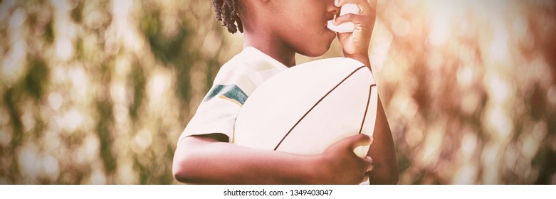 Child is using an asthma inhaler in park - Powered by Shutterstock