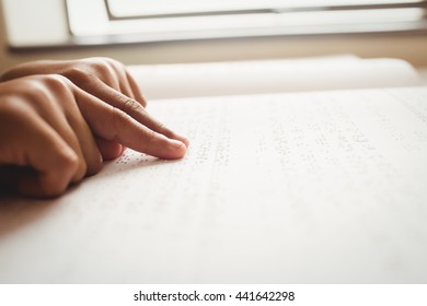 Child Using Braille To Read At School