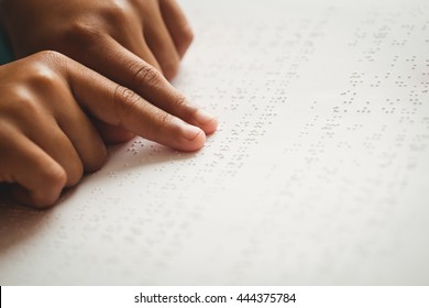 Child Using Braille To Read At School