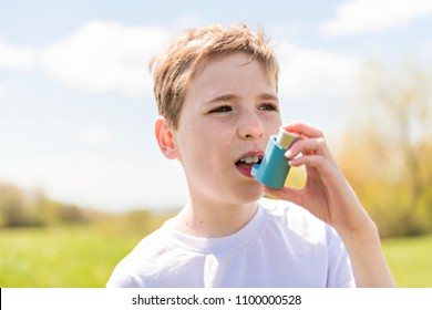 Child Using Inhaler For Asthma Outside In A Park