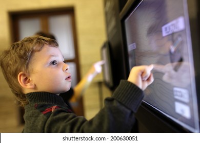 Child Using Interactive Touch Screen In A Museum