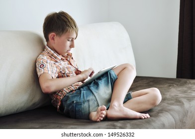 Child  using a tablet computer indoor 