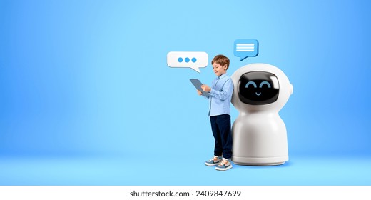 Child using tablet, standing full length near cartoon AI chat bot, speech bubbles on copy space empty blue background. Concept of virtual assistant, technology and machine learning - Powered by Shutterstock