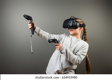 Child With Virtual Reality Headset And Joystick Playing Video Games