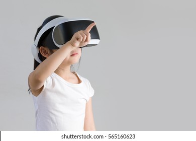 Child With Virtual Reality, VR, Headset Studio Shot Isolated On White Background. Kid Exploring Digital Virtual World With VR Goggles.