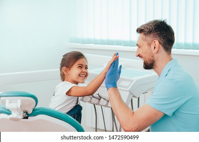 Child Visit Dentist. Laughing Little Girl Have Five To Dentist At Dental Clinic