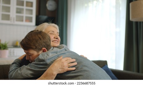 A child visiting his grandmother during the feast (Ramadan or Şeker Bayram). People who adhere to Muslim traditions. Child hugs his grandmother, happy to see each other, celebrates traditional holiday - Powered by Shutterstock