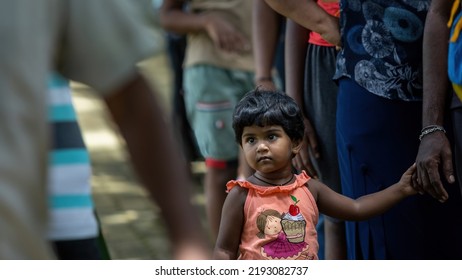 Child Waiting To Receive Food Parcel From A Community Almsgiving: Galle, Sri Lanka 30th July 2022