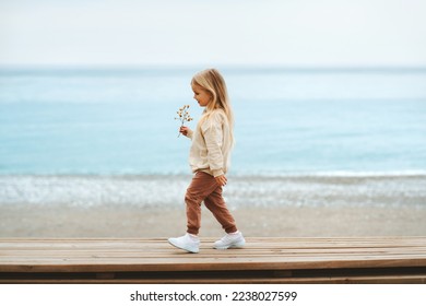 Child walking on the beach girl 4 years old family travel outdoor vacations trip - Powered by Shutterstock