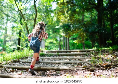 A Child Walking On The Steps Of The Forest