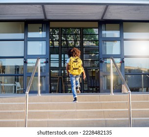 Child, walking and school entrance for education, learning or childhood development at academy building. Kid having a walk up the steps ready for back to school morning with backpack for knowledge - Shutterstock ID 2228482135