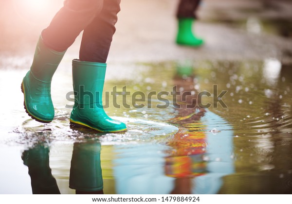 子どもは雨天に乗って はねつけ 水たまりに飛び乗る 夏の屋外で雨が降っている少年 の写真素材 今すぐ編集