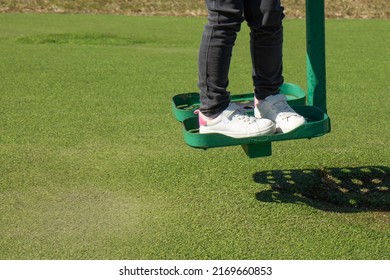 Child walks on playground. Active pastime on the simulator in the fresh air